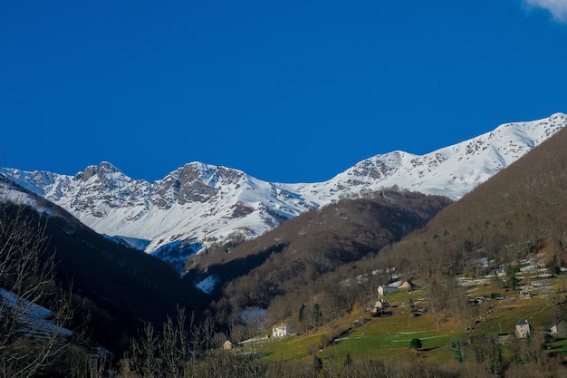 Scenic view of snowcapped mountains against clear blue sky