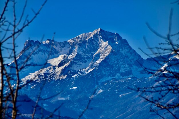 Scenic view of snowcapped mountains against clear blue sky