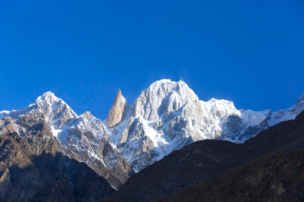 Scenic view of snowcapped mountains against clear blue sky