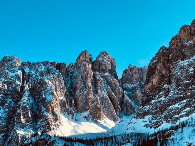 Scenic view of snowcapped mountains against clear blue sky