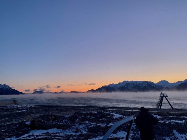 Scenic view of snowcapped mountains against clear sky during winter