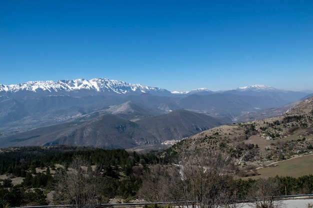 Scenic view of snowcapped mountains against clear sky