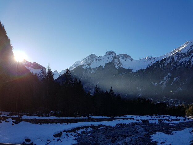 Scenic view of snowcapped mountains against clear sky