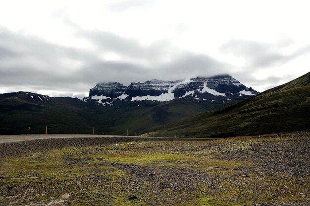 Scenic view of snowcapped mountains against cloudy sky