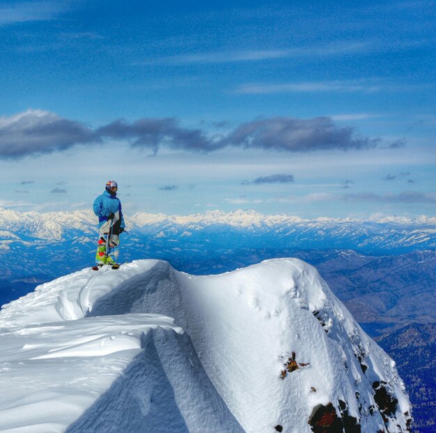 Scenic view of snowcapped mountains against cloudy sky