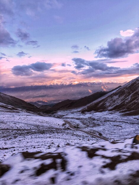 Scenic view of snowcapped mountains against sky during sunset