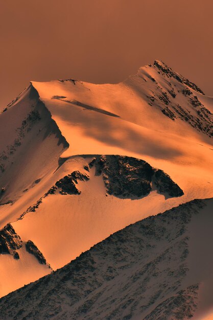 Scenic view of snowcapped mountains against sky during sunset