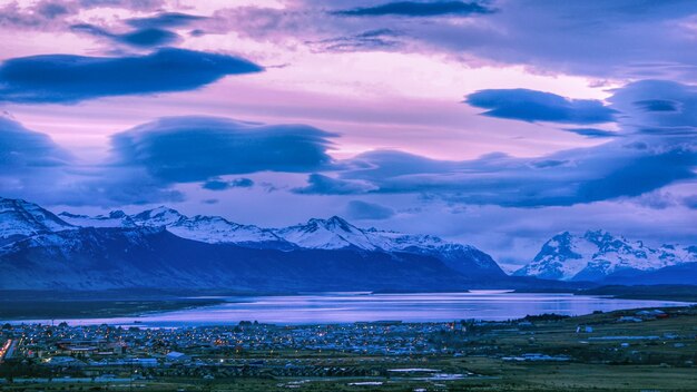 Scenic view of snowcapped mountains against sky during sunset