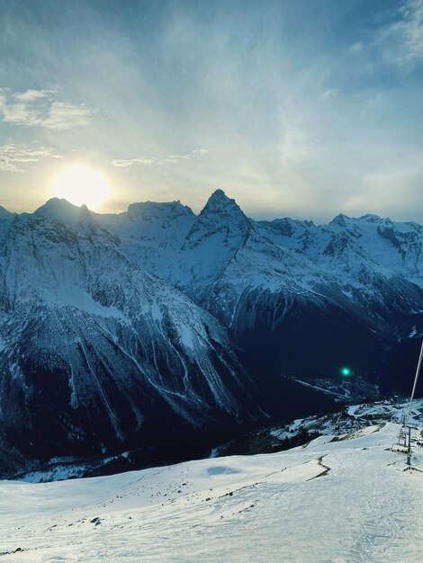 Scenic view of snowcapped mountains against sky during sunset