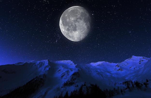 Scenic view of snowcapped mountains against sky at night