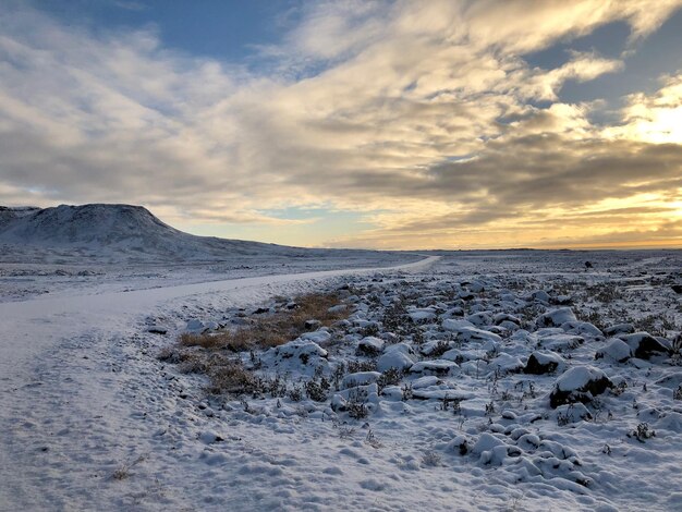 Scenic view of snowcapped mountains against sky during sunset