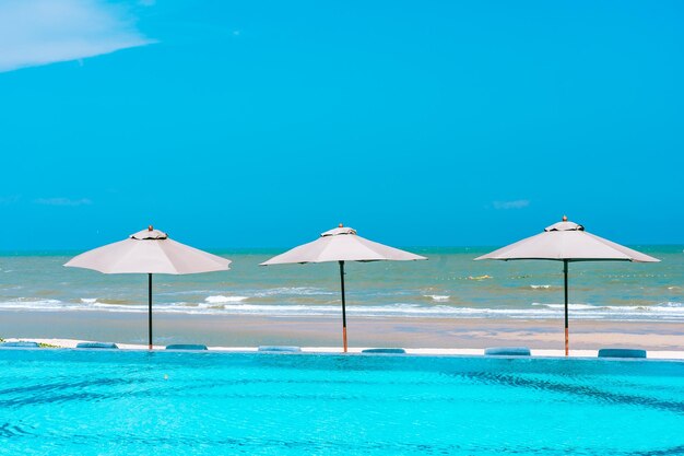 Scenic view of swimming pool by sea against clear blue sky