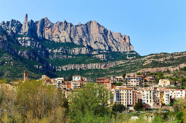 scenic view of town against montserrat mountains against clear sky