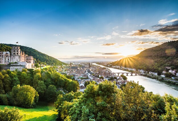 Scenic view of townscape against sky at sunset