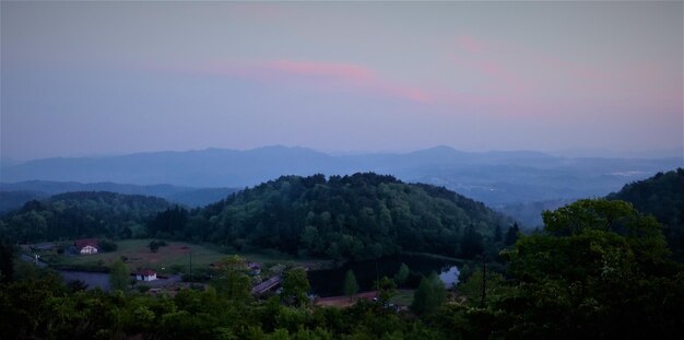 Scenic view of tree mountains against sky