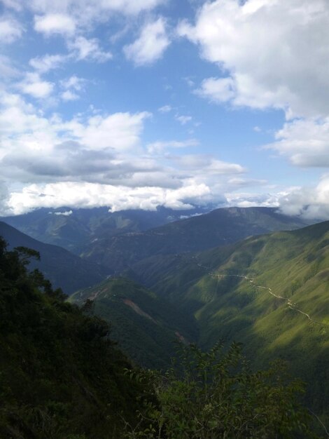 Scenic view of valley and mountains against sky