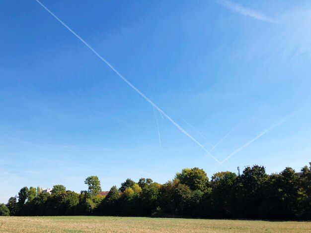 Scenic view of vapor trail against blue sky