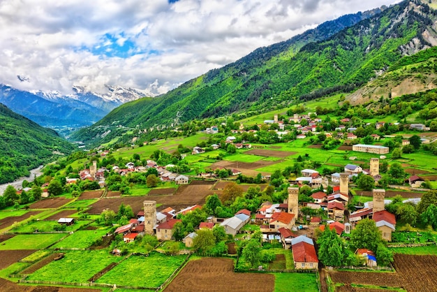 Scenic view of village and houses against sky