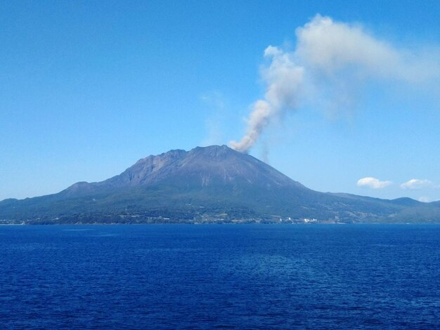 Scenic view of volcanic mountain against blue sky