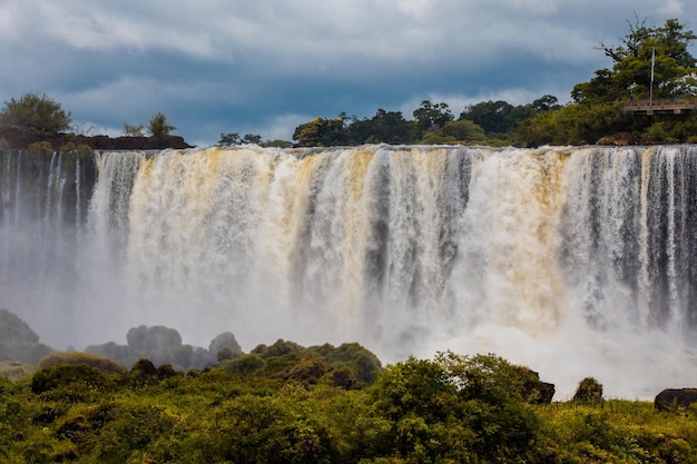 Scenic view of waterfall against sky