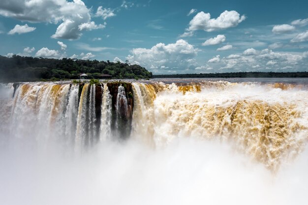 Scenic view of waterfall against sky