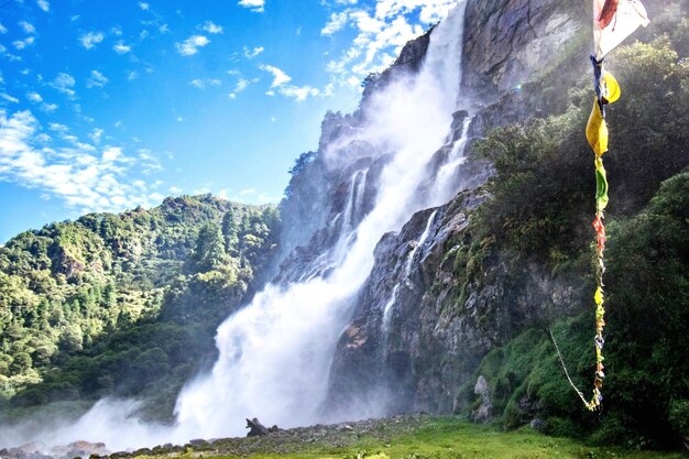 Scenic view of waterfall against sky