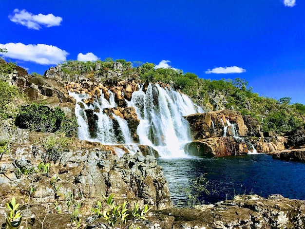 Scenic view of waterfall against sky