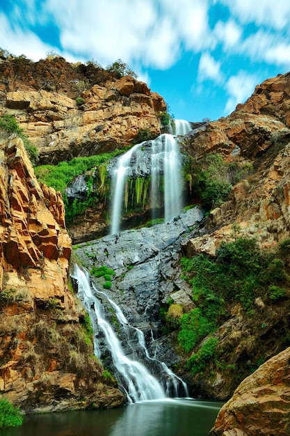 scenic view of waterfall over rock formations