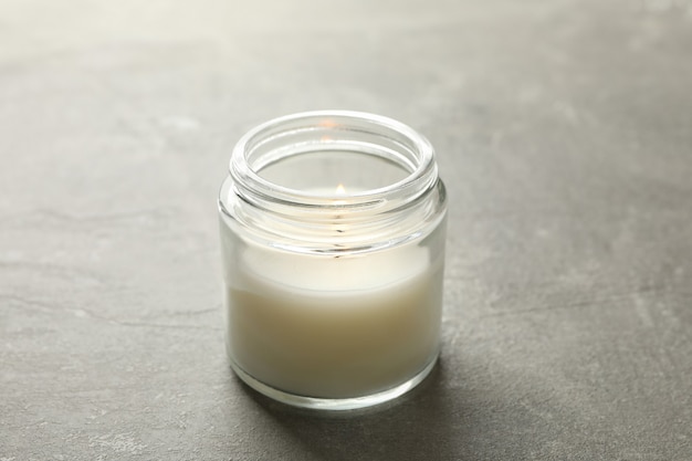 Scented candle for relaxation on gray surface