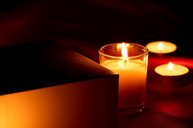 Scented candles in the dark night on a red cloth ceremony hope romantic