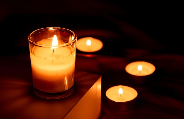Scented candles in the dark night on a red cloth ceremony hope romantic