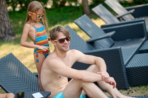 Schattig jong gezin dat tijd doorbrengt met zonnebaden