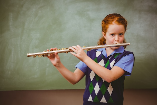 Schattig klein meisje spelen fluit in de klas