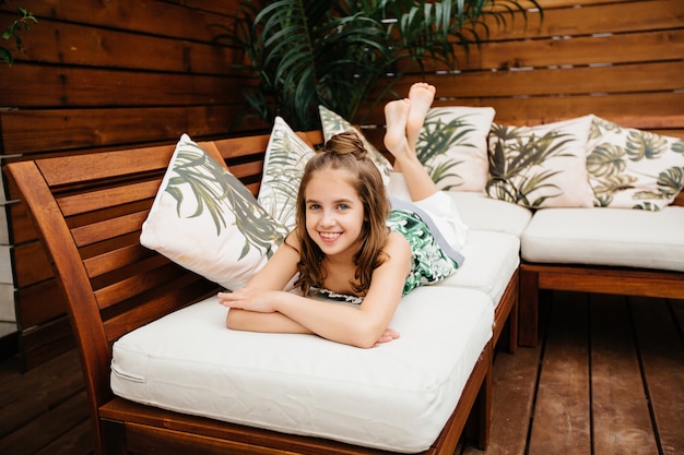 Schattig meisje ontspannen op de sofa, zomer