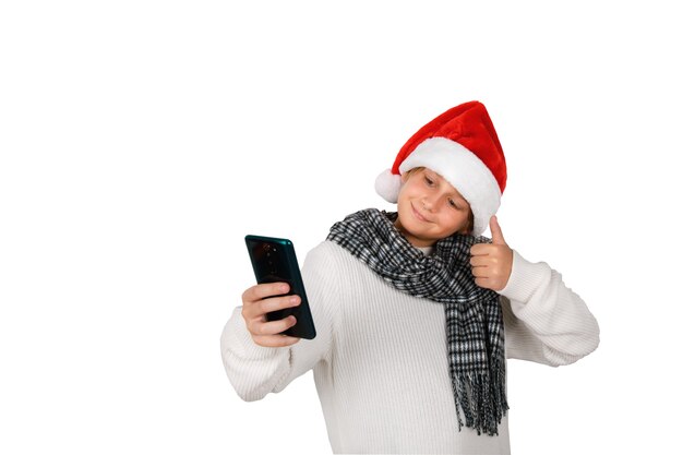 Schattige lachende jongen met rode kerstmuts selfie te nemen