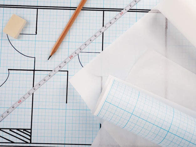 Photo schematic plan of the apartment, drawing on millimeter paper in a roll. builder concept of repair and design.