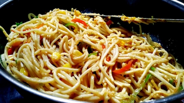 Schezwan Noodles or Szechwan vegetable Hakka Noodles or chow mein is a popular IndoChinese recipes served in a bowl or plate