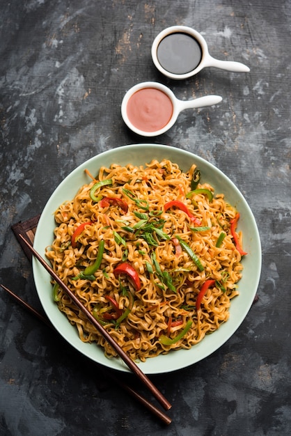 Schezwan veg noodles is a spicy and tasty stir fried flat Hakka noodles with sauce and veggies