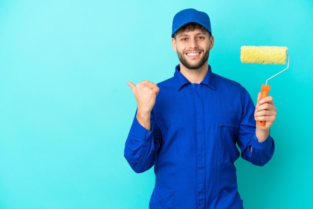 Schilder blanke man geïsoleerd op blauwe achtergrond wijzend naar de zijkant om een product te presenteren