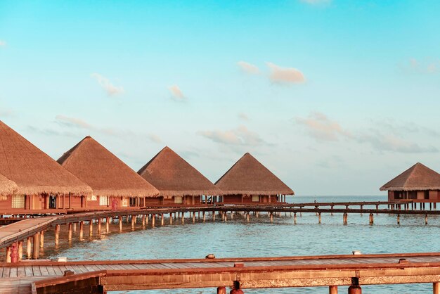 Schilderachtig uitzicht op de watervilla's bij zonsopgang op de Malediven het concept van luxe reizen