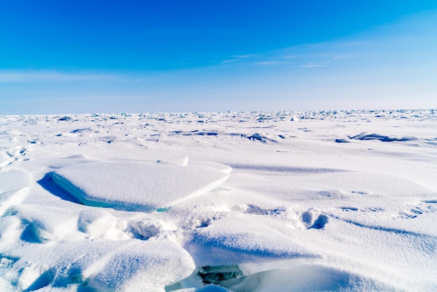 Schilderachtig uitzicht op sneeuwbedekt land tegen een blauwe hemel