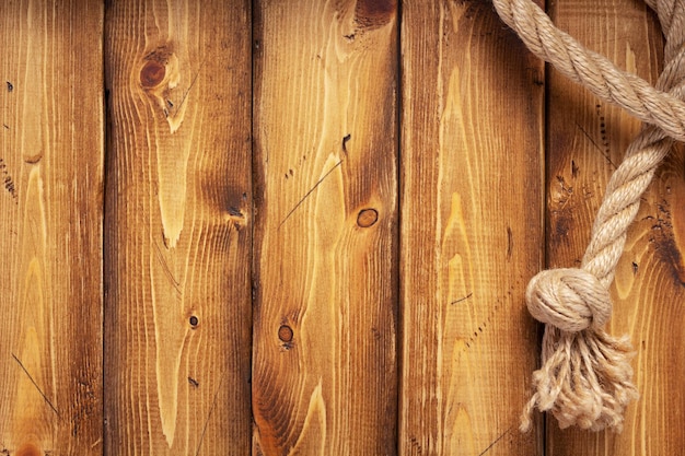 Schip touw grens bij houten plank achtergrondstructuur