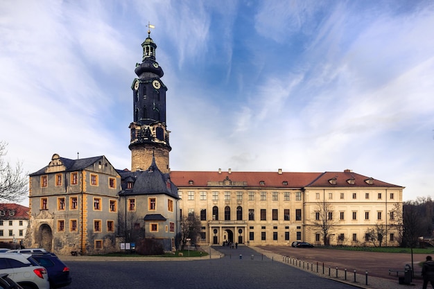 Schloss Weimar в окружении автомобилей под голубым облачным небом в Веймаре, Тюрингия, Германия