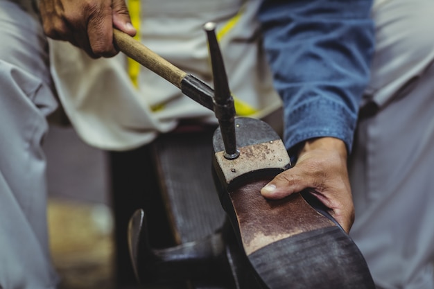 Schoenmaker hameren op een schoen