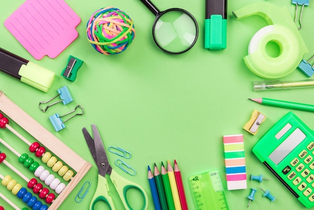 School Accessories on Green Background Flat Lay Back To School Concept