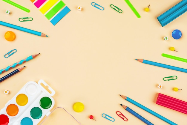 School accessories on a yellow table. Pastel colored.