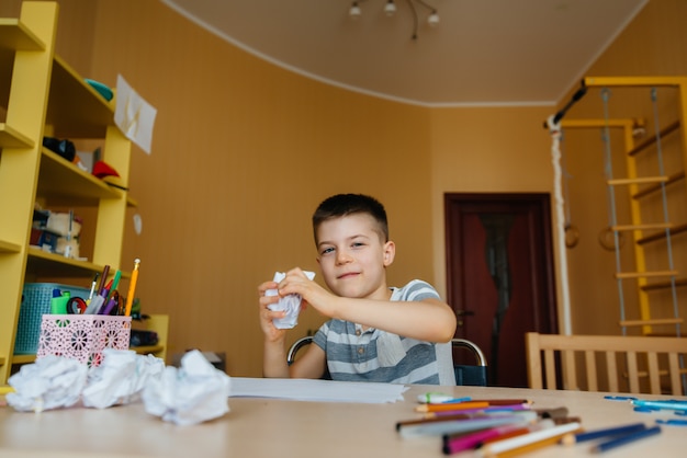 A school-age boy does homework at home. Training at school.