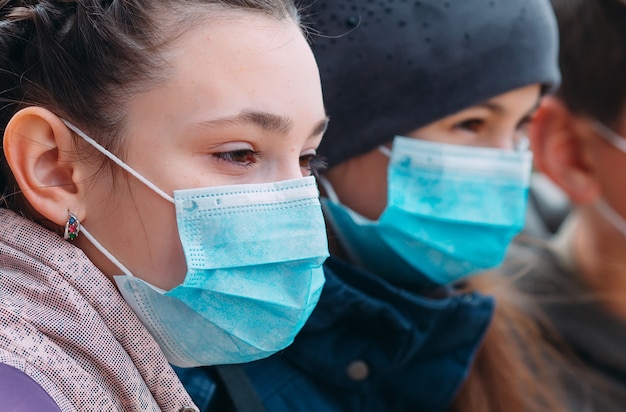 School-age children in medical masks. portrait of school children.