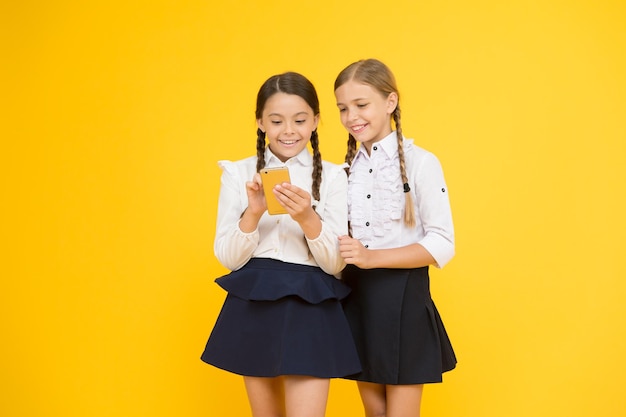 School application smartphone internet is wonderful resource but access to it has hazards for kids girls school uniform using smartphone schoolgirls use mobile phone or smartphone to share photos