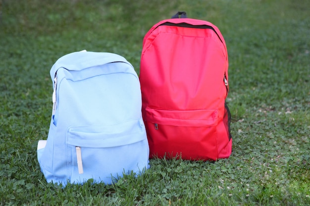 School backpack on the grass outside closeup